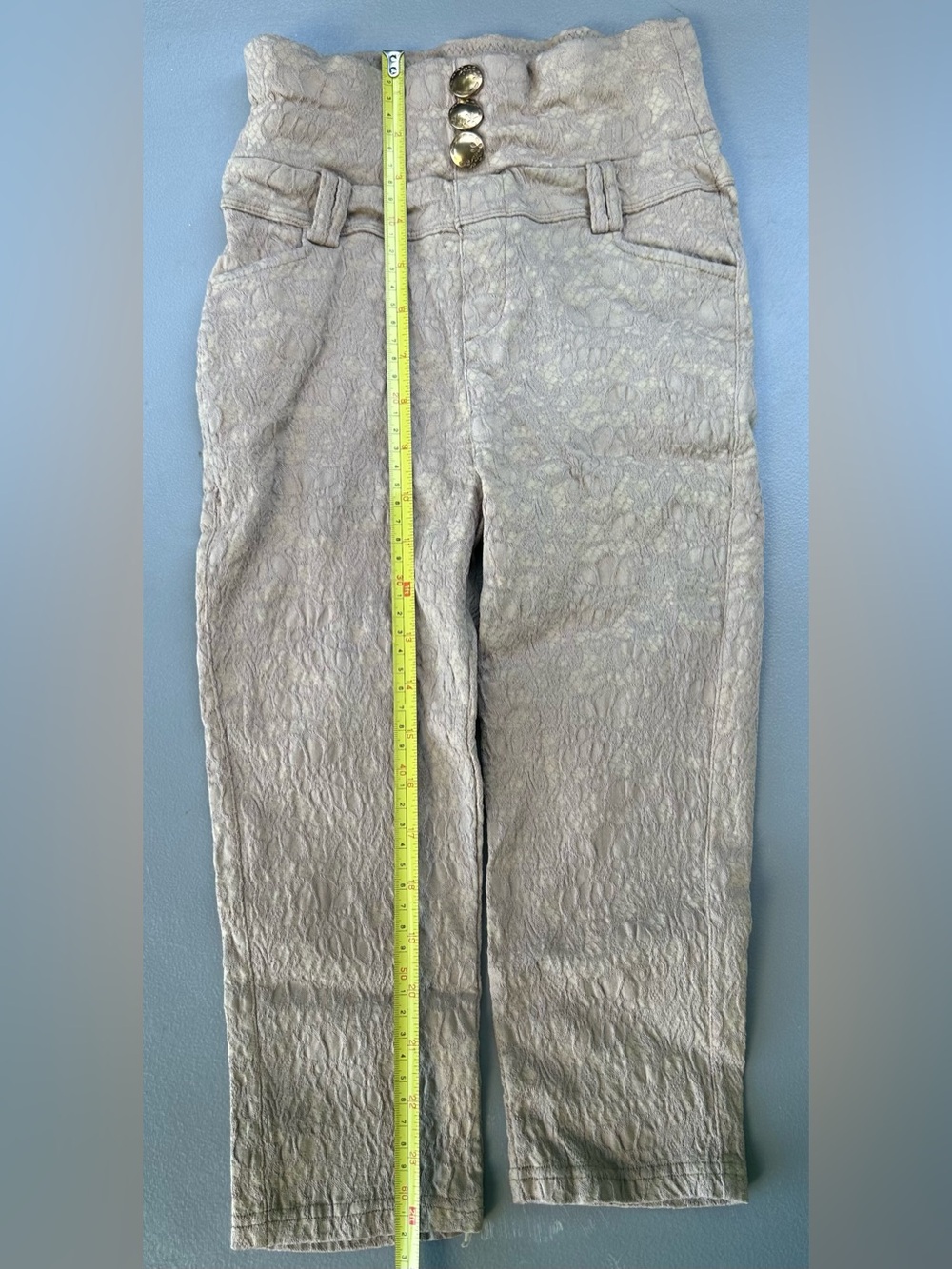 High-waisted brown trousers with button detail